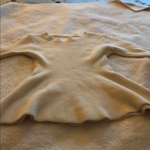 This size small sweater is wool and peplum.